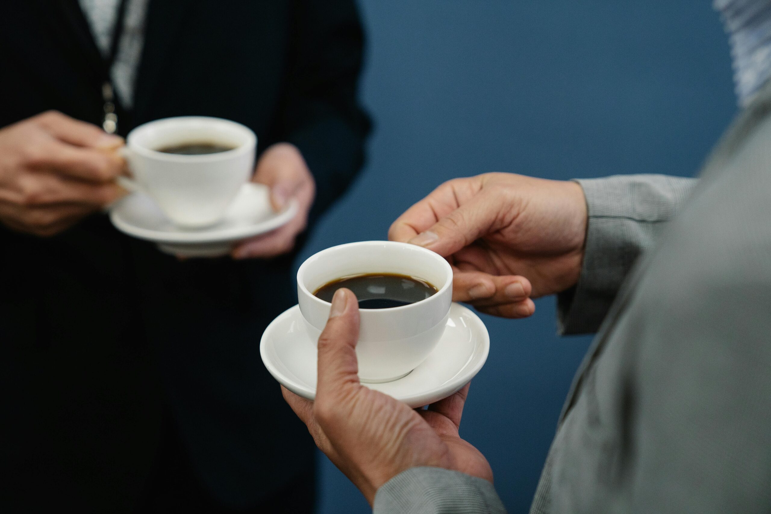 two people having coffee in suits